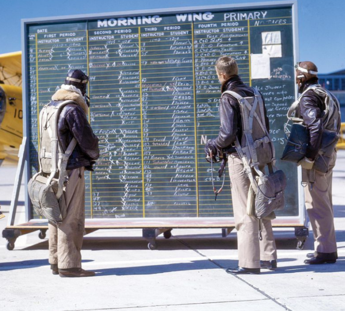 Cadets check the roster for their primary training flights in the Boeing-Stearman N2S.