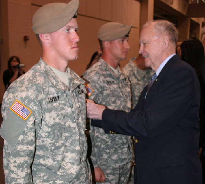 Retired Col. Ralph Puckett places the hard-earned 75th Ranger Regiment scroll on Pfc. Nathan Lively at the Ranger Assessment and Selection 1 graduation, March 5, 2010.