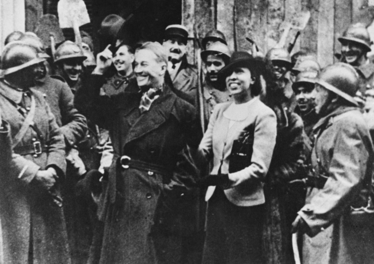 Maurice Chevalier and Josephine Baker surrounded by French soldiers