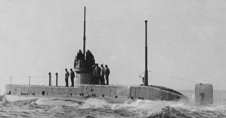 Crew standing atop the HMS D1 while she's at sea