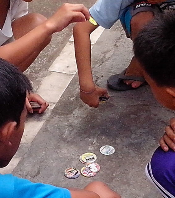 Children playing with pogs