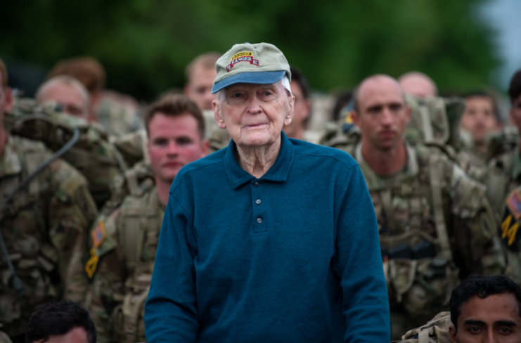 Ralph Puckett standing with US Army soldiers dressed in their military uniforms