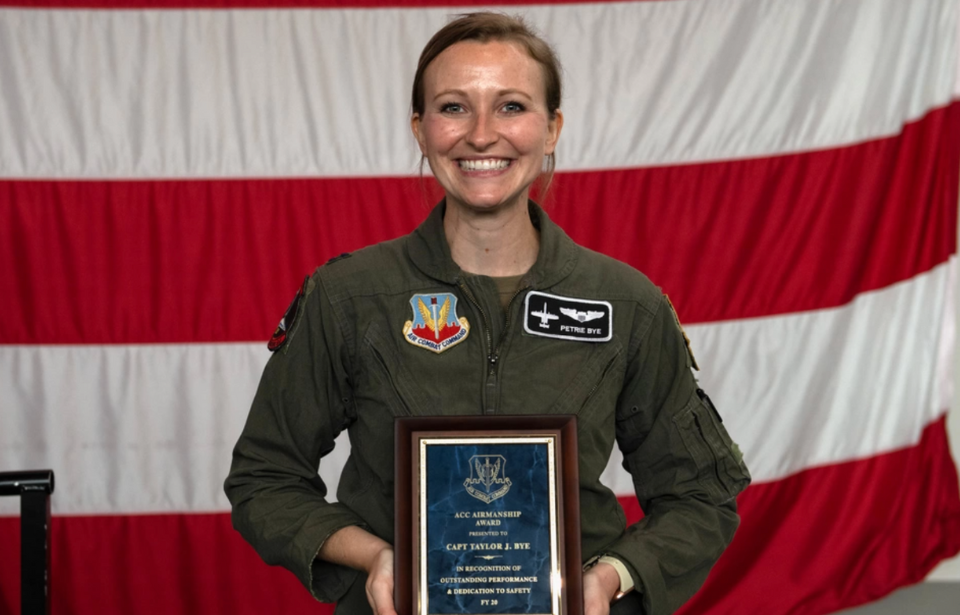 Taylor Bye holding her Air Combat Command Airmanship Award