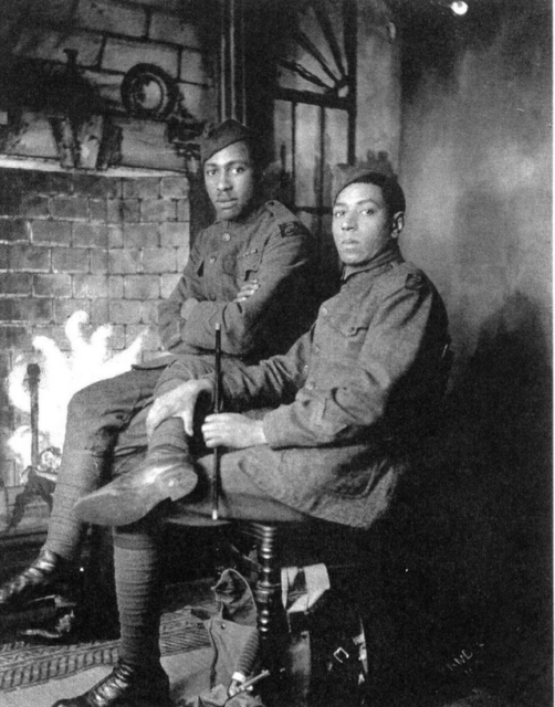 William Henry Johnson and Needham Roberts sitting in front of a fire