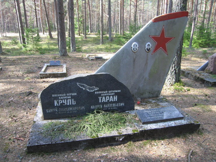 Aircraft tail positioned behind a gravestone at Ämari Pilots' Cemetery