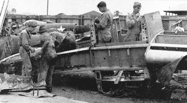 American troops working on a Bell P-39 Airacobra's fuselage