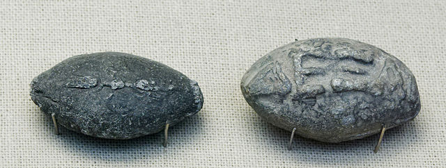 Two engraved ancient Greek sling bullets