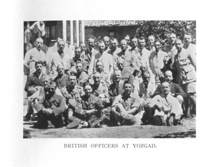 British prisoners of war standing together in civilian dress