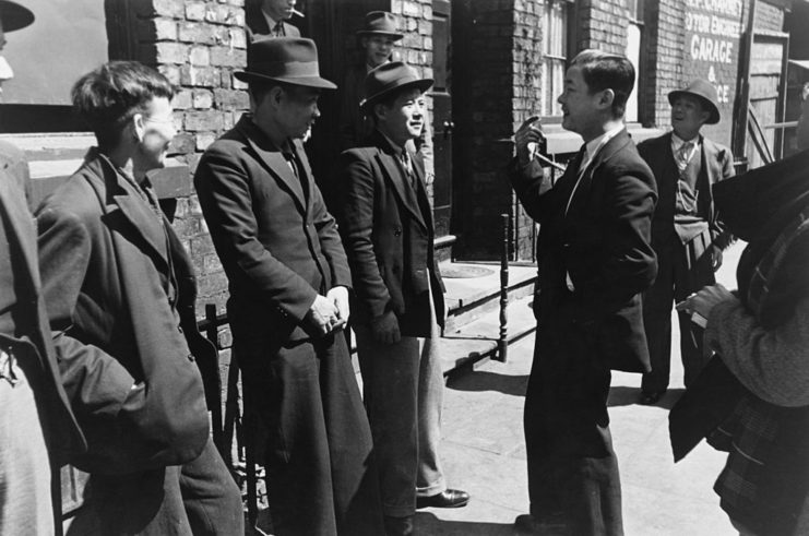 A group of Chinese seamen standing outside a hostel in Liverpool