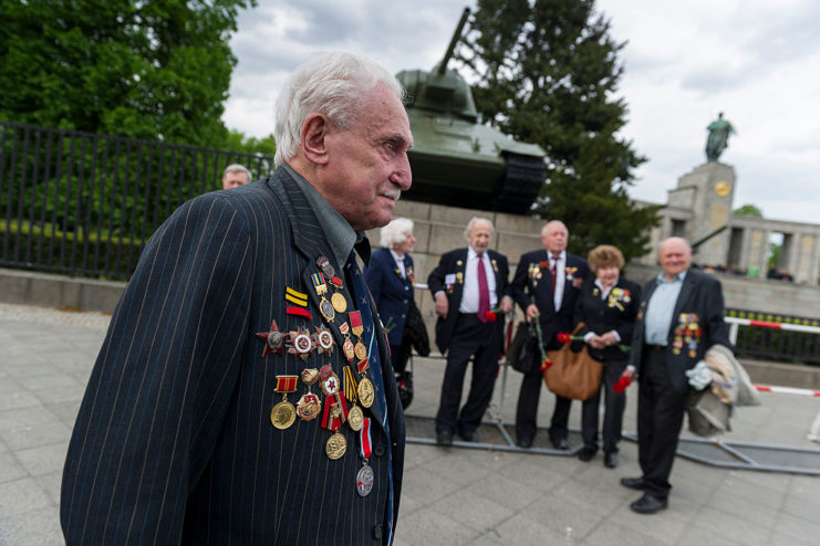David Dushman standing with other individuals at a World War II memorial