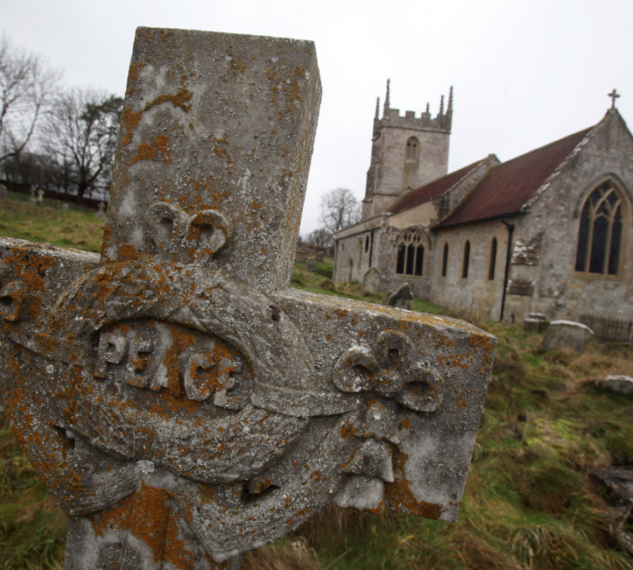 Headstones in the graveyard are seen as the 10th New Year's Eve peace vigil is held inside the 700-year-old St Giles church in the village of Imber on December 31, 2011 on Salisbury Plain, England.