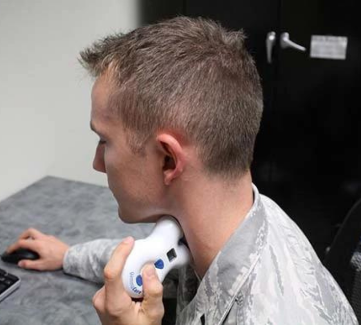 Airman demonstrating the use of the gammaCore® ctVNS device