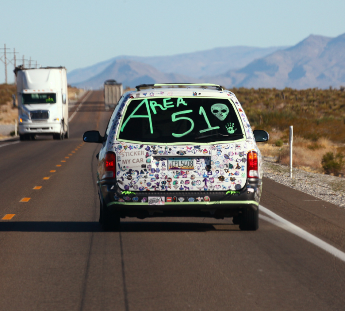 A car drives with 'Area 51' written on the back before the start of a 'Storm Area 51' spinoff event called 'Area 51 Basecamp' on September 20, 2019 near Alamo, Nevada.