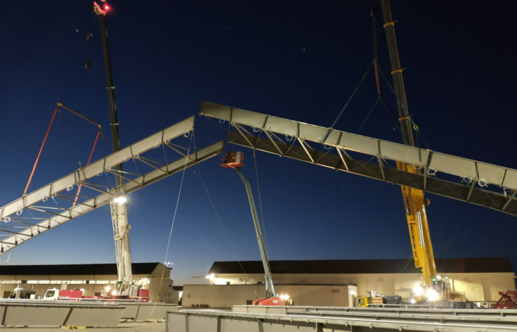 Contractors use cranes to place a pair of beams as part of the B-21 Raider Environmental Protection Shelter prototype construction project at Ellsworth Air Force Base, S.D., Jan. 28, 2021.