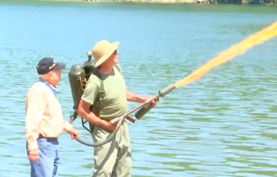 Hershel 'Woody' Williams, 97, (left) assists flamethrower expert Charles Hobson in flamethrower demonstration.