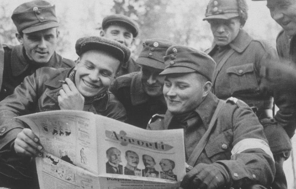 Finnish soldiers reading a newspaper