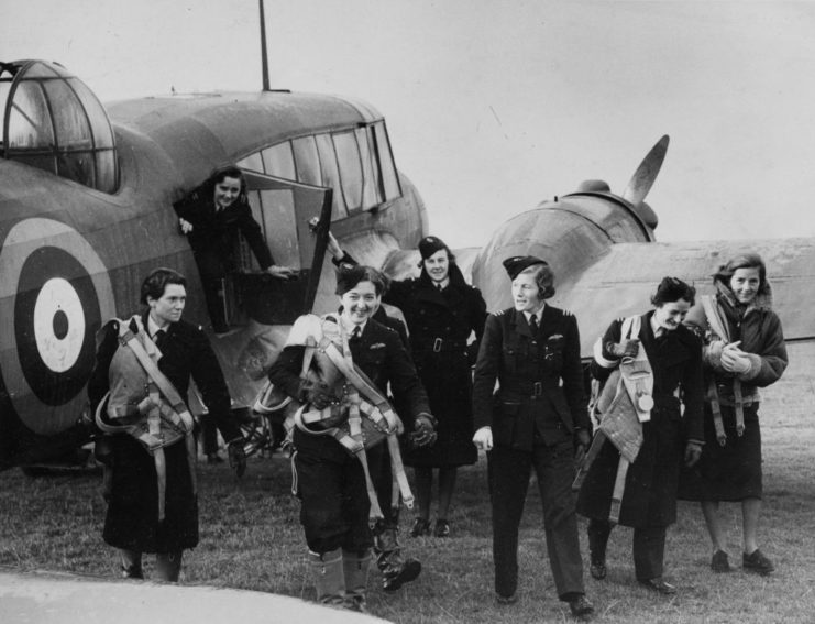 Pauline Gower walking away from an aircraft with members of the No. 5 Ferry Pilots Pool Women's Section of the Air Transport Auxiliary (ATA)