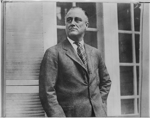 Franklin D. Roosevelt standing in front of a building