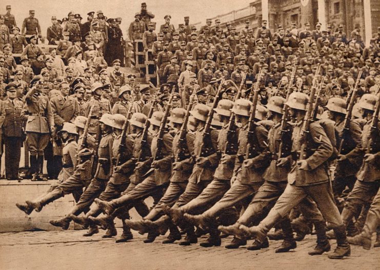 Rows of German soldiers marching down a street in Vienna, Austria