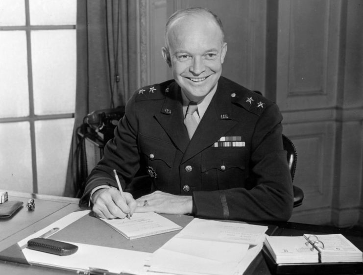 Dwight D. Eisenhower sitting at his desk