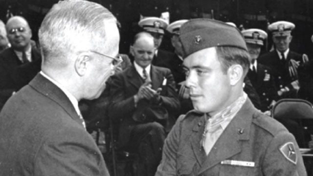 Harry Truman, President of the United States, congratulates Hershel "Woody" Williams on being awarded the Medal of Honor. 