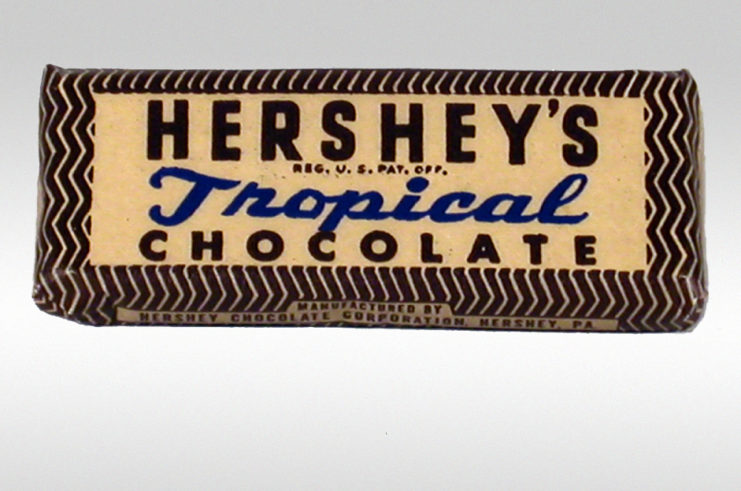 Hershey's Tropical Chocolate bar against a grey backdrop