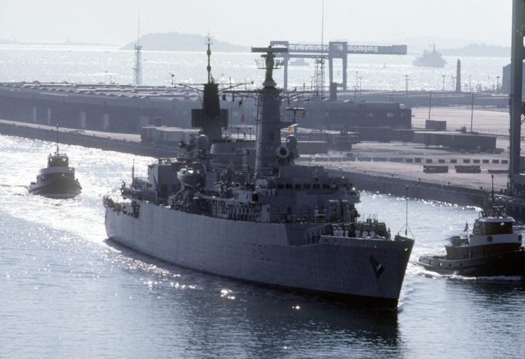 The British frigate HMS Brilliant (F90) enters a port accompanied by tugs during exercise Ocean Safari '85.