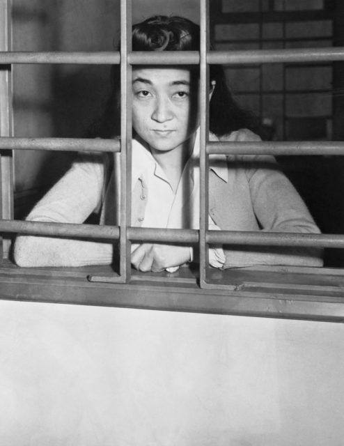 Iva Toguri D'Aquino standing in a prison cell