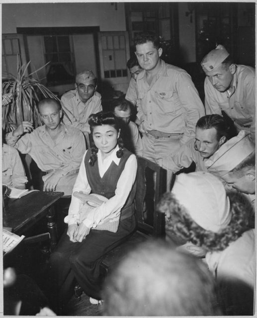 Iva Toguri D'Aquino surrounded by war correspondents