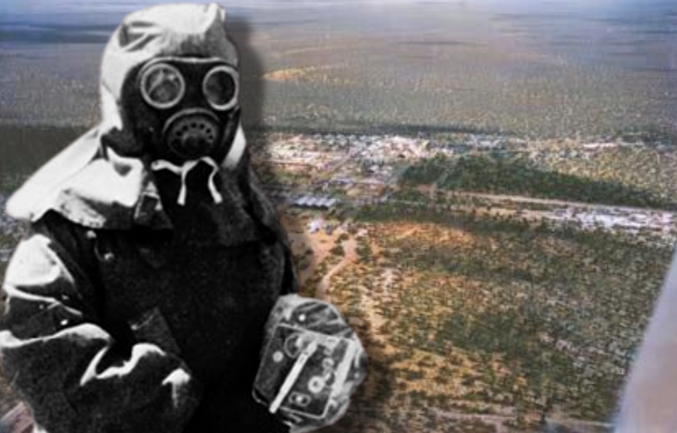 Aerial view of Maralinga + John L. Stanier dressed in protective gear