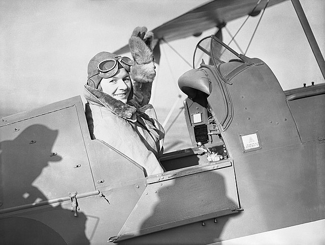 Pauline Gower waving from the cockpit of her plane