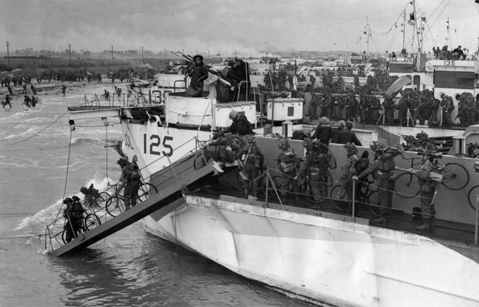 Canadian Troops with the 3rd Division disembarking from a ship with bicycles