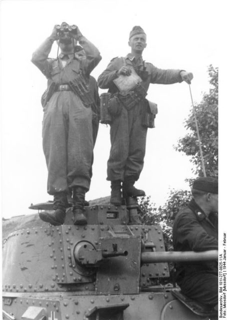 Two soldiers on top of a Panzer 38(t) 
