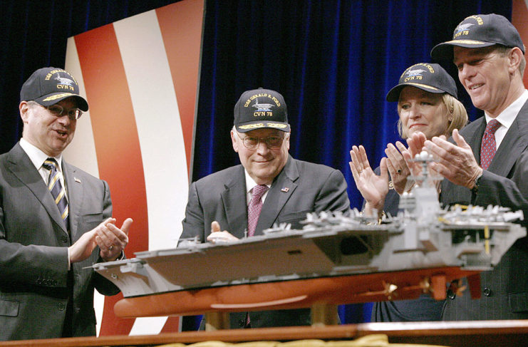 Former U.S. Vice President Dick Chaney applauds a model of the USS Gerald R. Ford