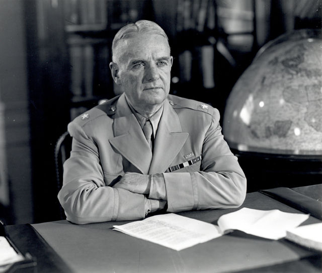 Bill Donovan sitting at his desk