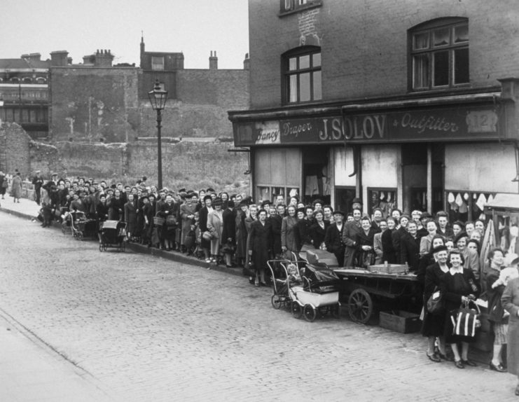 People lined up in front of a grocery store 