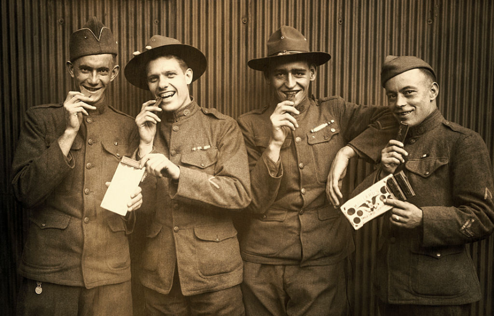 Four British soldiers eating chocolate