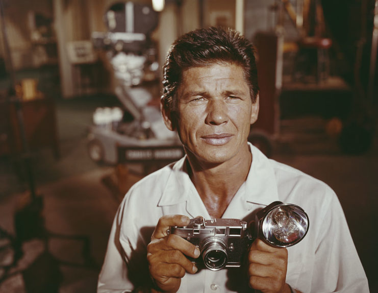 Charles Bronson holding a camera