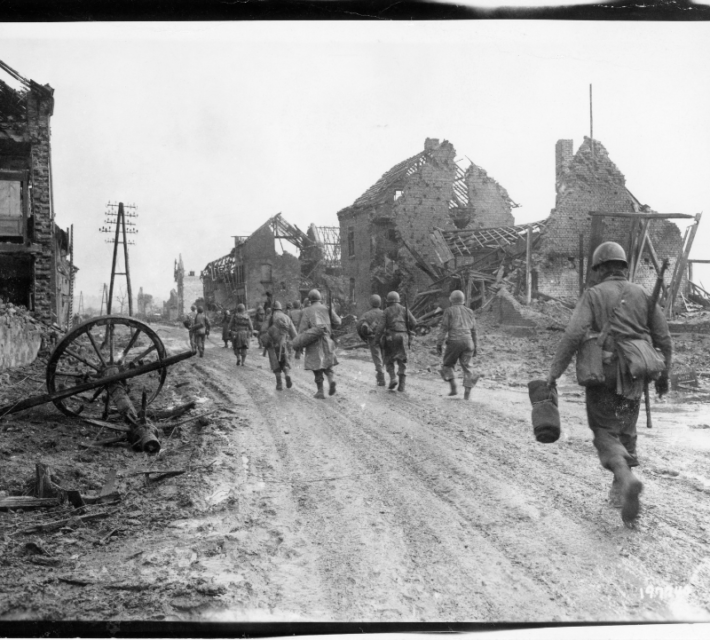 American infantrymen move through Hurtgen, Germany, on their way to the front lines.
