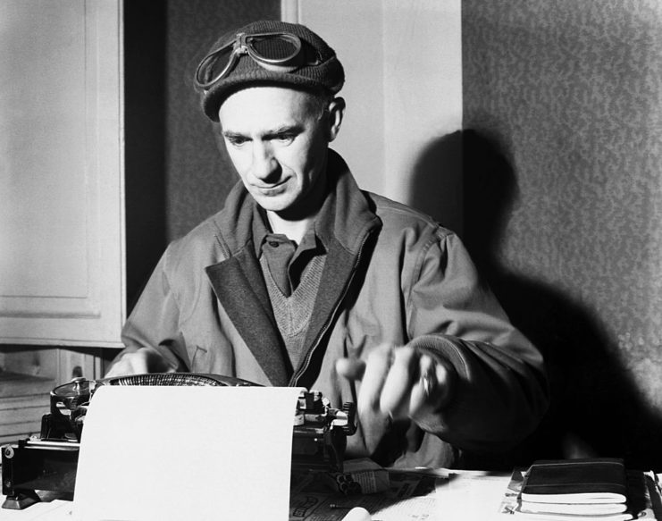 Ernie Pyle typing on a typewriter at his desk