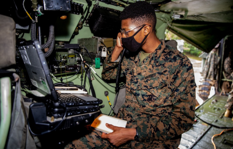 U.S. Marine Corps Cpl. Davaney Pierre, a satellite communications operator with 1st Battalion, 3rd Marine Regiment, currently attached to 3rd Marine Division under the Unit Deployment Program, receives communications during a long range precision fire exercise on Camp Schwab, Okinawa, Japan, Sept. 9, 2020.