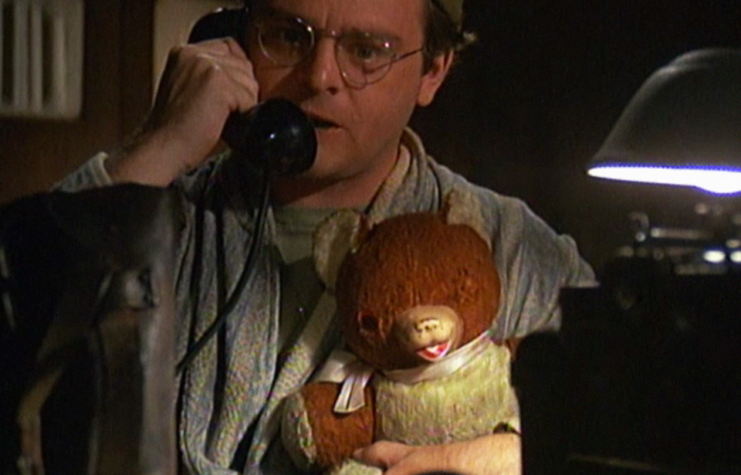 Radar O'Reilly on the phone holding his teddy bear in a scene from M*A*S*H