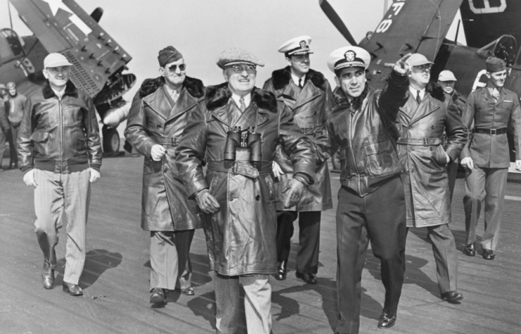 President Truman is shown on the flight deck of the giant aircraft carrier USS Franklin D. Roosevelt as he watched the first post-war maneuvers off the Virginia Capes.