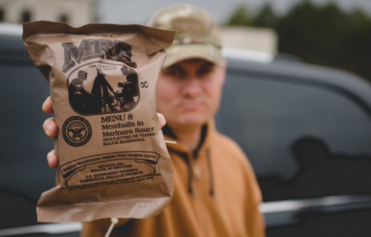 Man holding MRE aloft