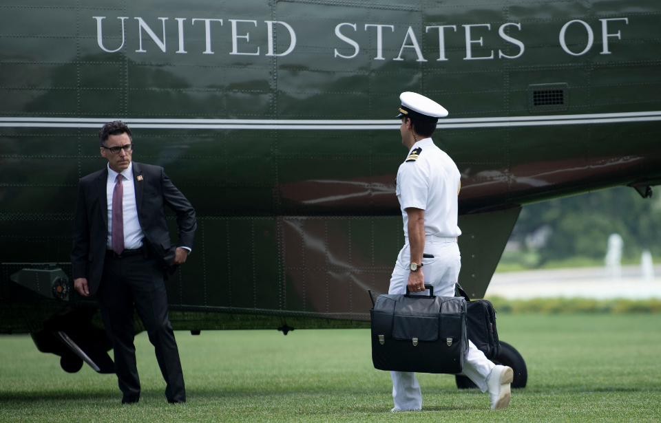 A military aid with the "nuclear football" follows US President Joe Biden to Marine One on the South Lawn of the White House July 21, 2021, in Washington, DC.