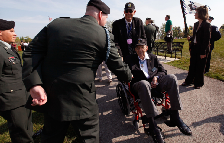 WWII veteran and Congressional Medal of Honor recipient Van Barfoot is greeted by a soldier as he heads to Soldier Field for the opening ceremony for the Medal of Honor Society Convention September 15, 2009 