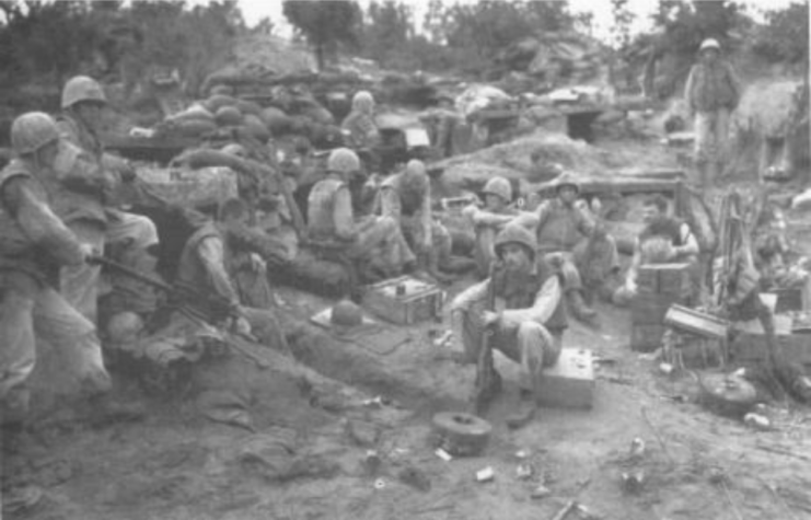 Tired Marines of Company F, 2d Battalion, 1st Marines, unwind during a pause in the fighting on Bunker Hill in Korea, Aug. 13, 1952. 