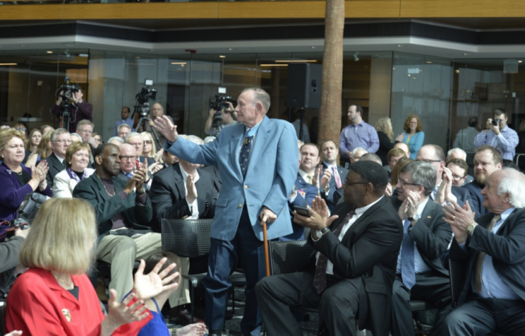 Korean War Medal of Honor recipient and Detroit native Marine Corps Pfc. Robert E. Simanek, 85, is recognized by former Sen. Carl M. Levin, elected officials and distinguished guests during a naming ceremony at the GM Renaissance Center in Detroit. 