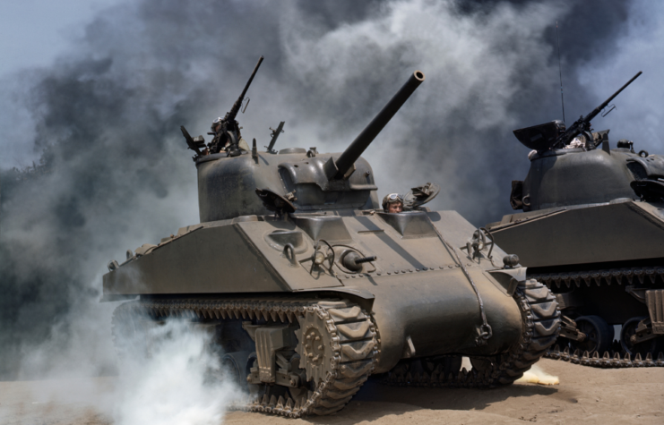 View of a pair of M4 Sherman tanks as they manouver through smoke during a training exercise, July 1942.