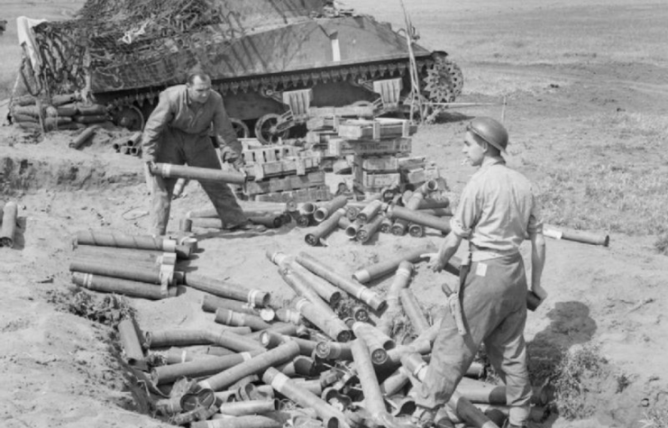 Empty 75mm HE shell cases being collected from Sherman tanks firing in the indirect fire support role in the Anzio bridgehead, Italy, 5 May 1944.